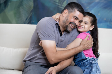 Portrait of father and daughter at home having fun together