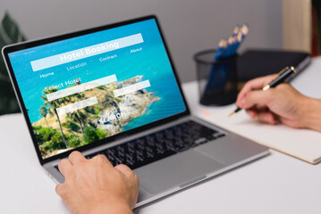 booking online concept, person using laptop computer planning travel search hotel booking.