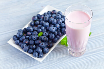 Fototapeta na wymiar blueberry yogurt and ripe berries on a kitchen table