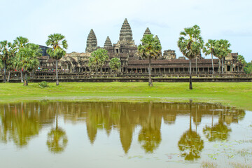 Fototapeta na wymiar Angkor Wat temple reflecting in water of Lotus pond. Siem Reap. Cambodia. Panorama, copy space for text