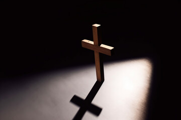 cross, wooden cross illuminated by a small light in the dark