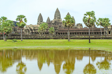 Fototapeta na wymiar Scenery of Angkor Wat across the lake and the reflection in the water during sunrise. UNESCO world heritage site in Cambodia