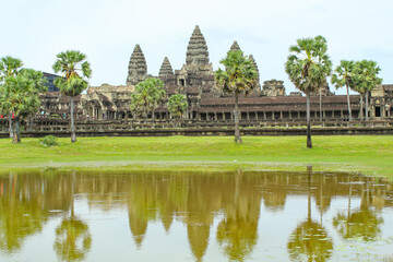 Fototapeta na wymiar Angkor Wat temple reflecting in water of Lotus pond. Siem Reap. Cambodia. Panorama, copy space for text
