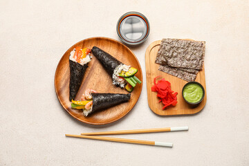 Composition with tasty sushi cones, ingredients and chopsticks on light background