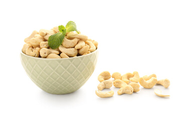 Bowl with tasty cashew nuts isolated on white background