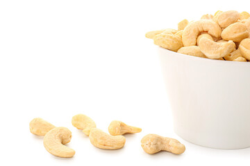 Bowl with tasty cashew nuts isolated on white background, closeup