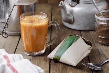 Hot drink Teh Tarik with coconut rice Nasi Lemak Bungkus is a popular breakfast in Malaysia
