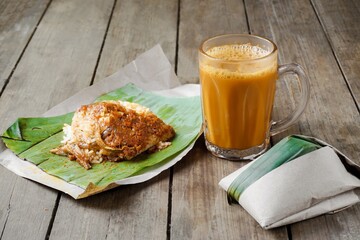 Hot drink Teh Tarik with coconut rice Nasi Lemak Bungkus is a popular breakfast in Malaysia