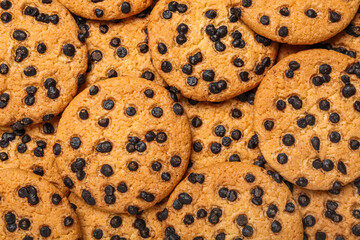 Tasty cookies with chocolate chips as background, closeup