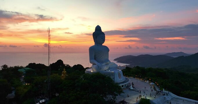 aerial view around Phuket big Buddha in beautiful sunset..360 degree view on Phuket big Buddha viewpoint..Video clips for travel and religious ideas..smooth cloud in stunning sky background.