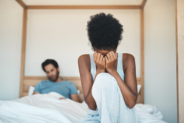 Couple, divorce and fight on bed in disagreement, argument or conflict in toxic relationship at home. Sad woman crying, cheating man person or partner in unhappy marriage or infertility in bedroom
