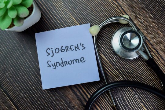 Concept of Sjogren's Syndrome write on sticky notes with stethoscope isolated on Wooden Table.