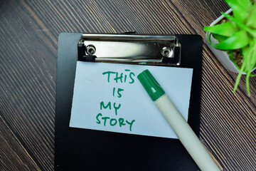 Concept of This is My Story write on sticky notes isolated on Wooden Table.