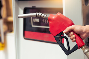 the gasoline nozzle and pump in the gas station