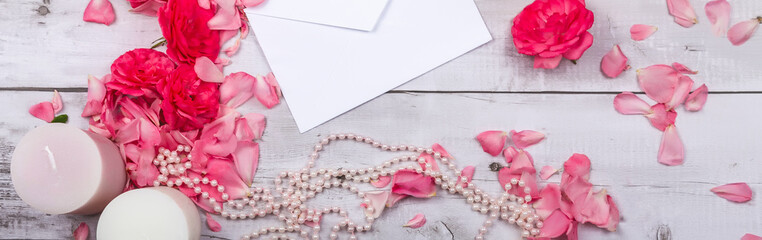 Spring flowers. Red flowers roses on a white wooden background. Flat lay, top view, space for placement. Birthday, Mother's, Valentines, Women's, Wedding Day concept.