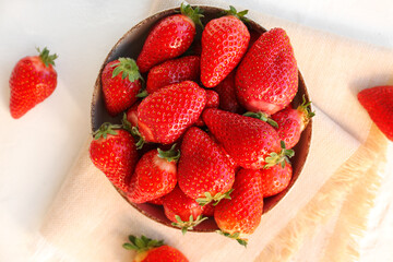 Bowl with fresh strawberries on white background