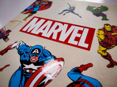 a book with the Marvel comics logo and drawings of famous superheroes on the cover.