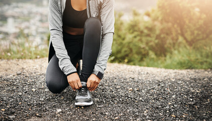 Closeup, exercise and woman outdoor, tie shoes and training with fitness, workout goal and target....