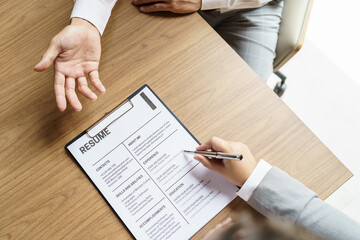 Examiner reading a resume during job interview at office Business and human resources concept