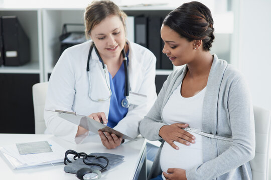 Talking, results and a doctor with a pregnant woman during a consultation for progress on a baby. Communication, smile and a hospital worker speaking to a patient about healthcare during a pregnancy
