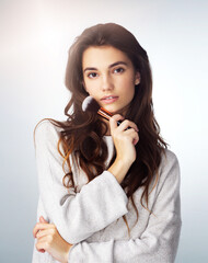 Face brush, natural makeup and beauty of a woman in studio with a glow. Portrait of a female model person on a grey background for cosmetology, facial powder and cosmetic tools or skin care