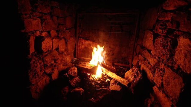 The warm orange glow of a fire in a fire place in the Victorian high country.