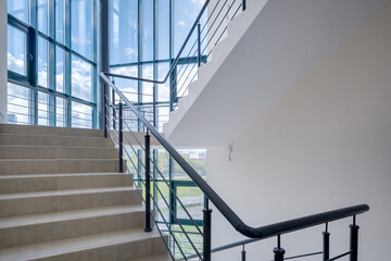 stairs emergency and evacuation exit stair in up ladder in a new office building. - Powered by Adobe