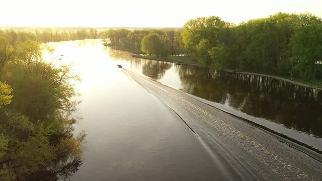 Aerial view of a fishing boat on the Wolf River in Fremont, Wisconsin known as the white bass capital of the world.  Sunny, sunrise, sunlight