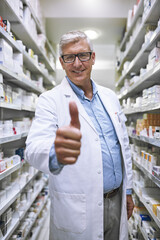 Senior man, doctor and thumbs up at pharmacy for winning, success or approval at clinic store. Portrait of happy elderly male or medical expert showing thumb emoji, yes sign or like in pharmaceutical