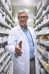 Senior man, pharmacist and handshake for introduction or greeting at a healthcare pharmacy. Portrait of happy elderly male person or medical expert shaking hands in pharmaceutical for health advice