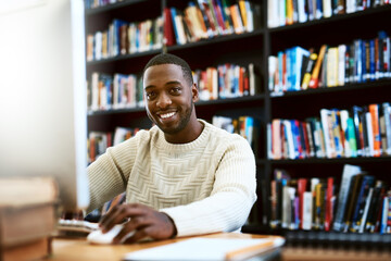 Portrait, education and black man in a library, computer or research for a project, assignment or...