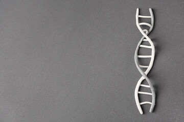 DNA molecule model made of grey plasticine on black background, top view. Space for text