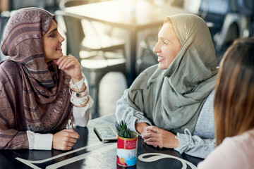 Smile, friends and Muslim women in coffee shop, bonding and talking together. Cafe, relax and Islamic girls, group or people chat, conversation and discussion for social gathering in restaurant.