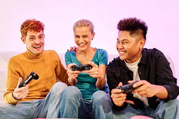 Happy multiethnic friends playing console at home