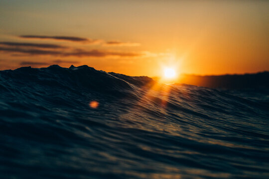 Sunrise behind the waves in St Ives bay.