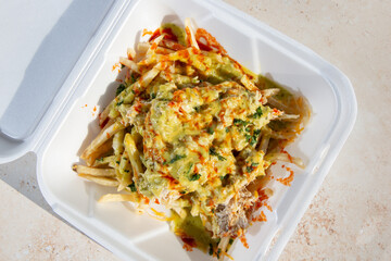 A top down view of a seafood loaded fries, featuring crab.