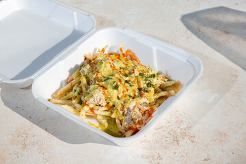 A view of a seafood loaded fries, featuring crab.