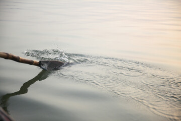 Oar of a row boat  in the water of the River Ganges India
