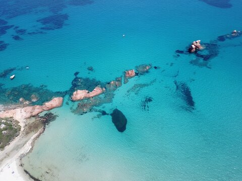 Aerial view of red rocks against blue Mediterranean Sea