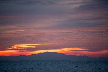 Fototapeta premium Colourful sunset sky. Full frame view of wispy colourful clouds up in the sky during sunrise or sunset hour. Sky replacement asset.