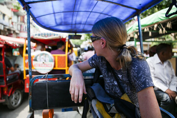 Woman looking back from inside a Tuk Tuk in Delhi India