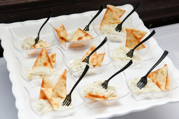 A view of a catered platter of crackers and dip.