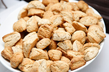 A view of a catered bowl full of mini scones.