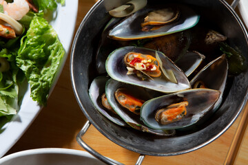 A top down view of an order of garlic steamed mussels.