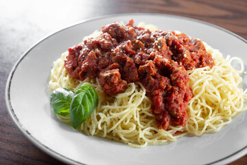 A view of a plate of spaghetti with marinara sauce.