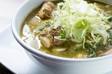 A view of a bowl of pozole verde.