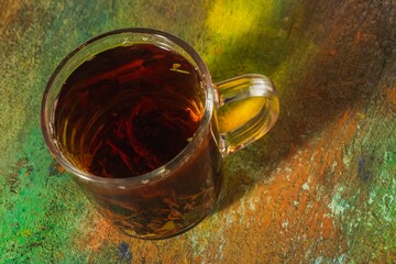 Still life - tea time. Mug of hot drink on a bright background - top view