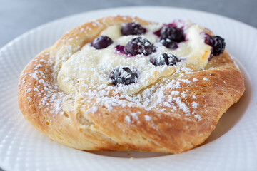 A closeup view of a blueberry cheesecake danish.