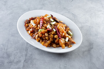 A view of a plate of a kung pao mix, featuring beef, chicken and shrimp.