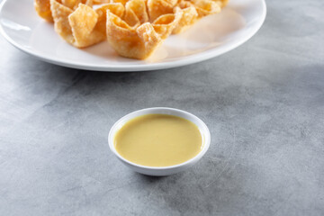 A view of a condiment cup of Chinese hot mustard.